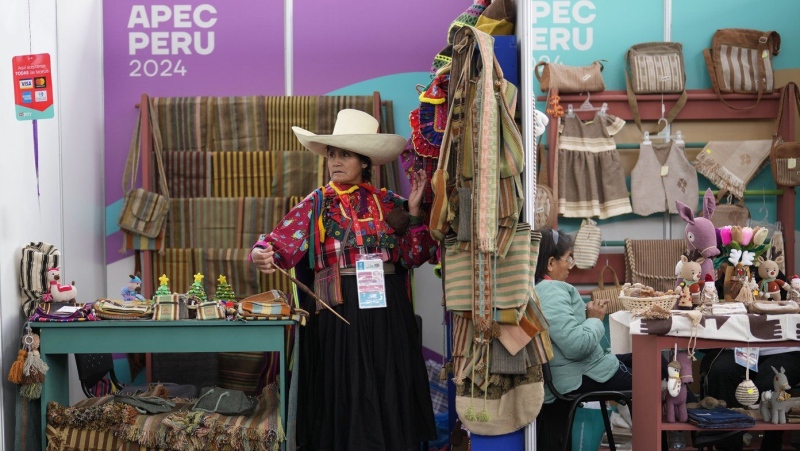 Mercedes Calderon spins wool at her stand at the Asia-Pacific Economic Cooperation (APEC) summit, in Lima, Peru, Tuesday, Nov. 12, 2024. THE CANADIAN PRESS/AP-Fernando Vergara