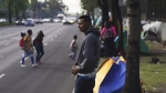 Jorge Menjivar, from El Salvador, stands outside the Northern Bus Station in Mexico City, Sept. 22, 2023, during his journey north to the U.S. (AP Photo/Marco Ugarte, File)