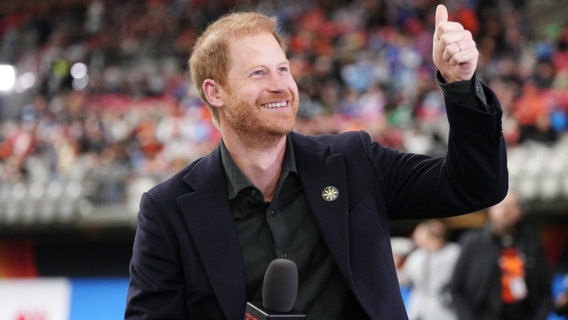 Prince Harry, the Duke of Sussex, rects to football fans during a pre-game television interview prior to first half CFL football action at the 111th Grey Cup in Vancouver on Sunday, November 17, 2024. (Darryl Dyck/The Canadian Press)