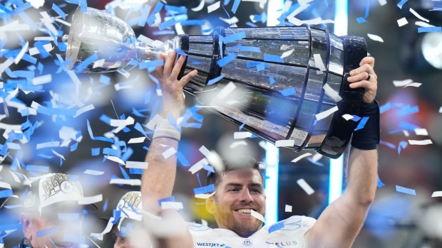 Toronto Argonauts quarterback Nick Arbuckle (4) hoists the Grey Cup after defeating the Winnipeg Blue Bombers in the 111th Grey Cup in Vancouver, Nov. 17, 2024. THE CANADIAN PRESS/Frank Gunn