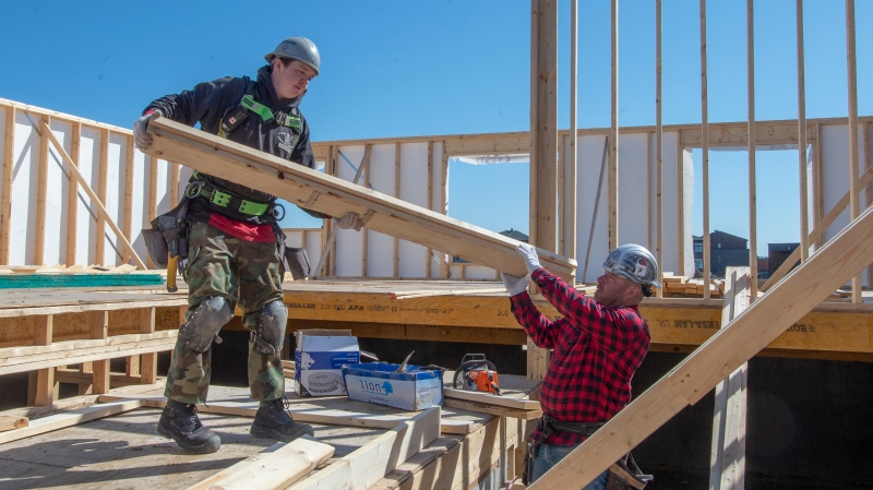 Construction workers work on a home in Deux-Montagnes, Que. on Monday, April 20, 2020. (Ryan Remiorz/The Canadian Press)