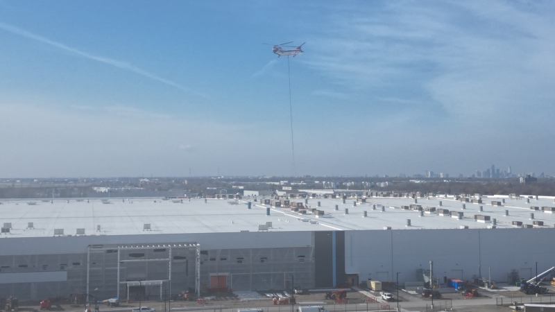 A helicopter hovering near E.C. Row Expressway and Banwell Road is helping install equipment at the new battery plant in Windsor, Ont., on Monday, Nov. 18, 2024. (Bob Bellacicco/CTV News Windsor)