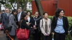 Representatives from various consulates wait in line outside the West Kowloon Magistrates' Courts in Hong Kong Tuesday, Nov. 19, 2024, ahead of the sentencing in national security case. (Chan Long Hei/AP Photo)