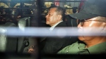 Benny Tai, centre, is escorted by a prison van at a court in Hong Kong, April 24, 2019. (AP Photo)