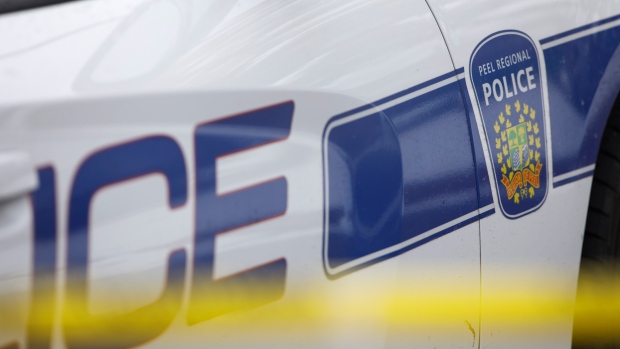 Peel Regional Police work the scene around a home in Brampton, Ont., on November 7, 2019. THE CANADIAN PRESS/Cole Burston