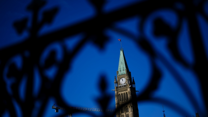 The Peace Tower is framed through the iron railing on Parliament Hill in Ottawa on October 24, 2024. THE CANADIAN PRESS/Sean Kilpatrick 