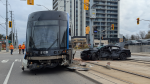 A damaged Grand River Transit ION train and black vehicle can be seen on King Street W. on Nov. 21, 2024. (Dan Lauckner/CTV News)