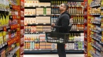 A customer shops in a new "small format" No Frills grocery store that the grocery chain is testing, in Toronto, May 30, 2024. THE CANADIAN PRESS/Chris Young