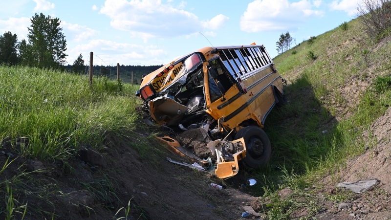 The wreckage of a school bus that crashed near Lac La Hache, B.C., in June 2024 is seen in an RCMP handout image. 