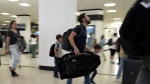 Travellers walk through the concourse at Miami International Airport on May 23, 2024, in Miami. (AP Photo/Lynne Sladky, File)