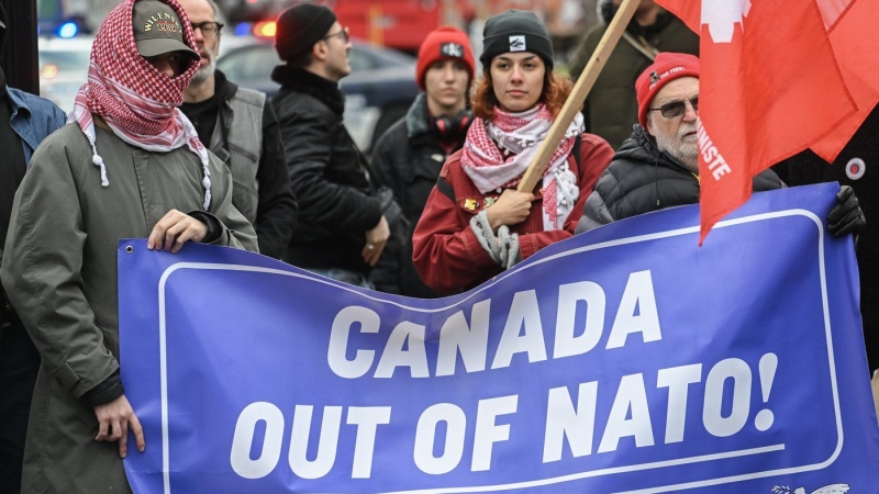 People take part in a protest against NATO in Montreal, Saturday, Nov. 23, 2024. THE CANADIAN PRESS/Graham Hughes