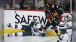 Minnesota Wild's Ryan Hartman, left, misses a check on Calgary Flames' Martin Pospisil during second period NHL hockey action in Calgary on Saturday, Nov. 23, 2024.THE CANADIAN PRESS/Jeff McIntosh