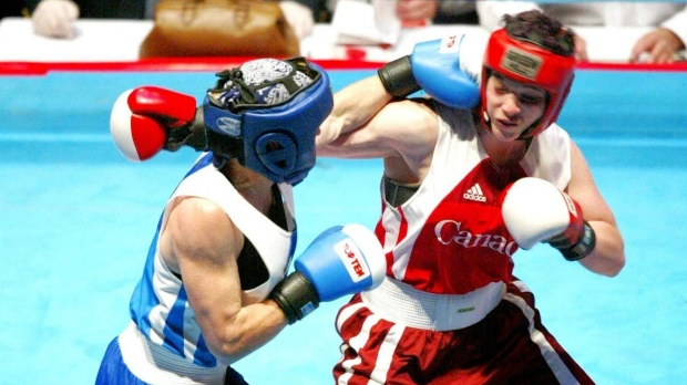 Jennifer Ogg (blue) throws a punch in a Canadian Championship fight. (Source: Jennifer Ogg) 