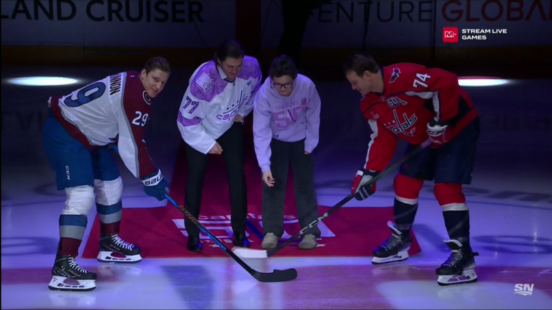 Sherwood Park's Kalen Anderson, third from left, drops the puck for Nathan MacKinnon, left, and John Carlson, right, alongside TJ Oshie before a Nov. 21, 2024, NHL game between the host Washington Capitals and the Colorado Avalanche.