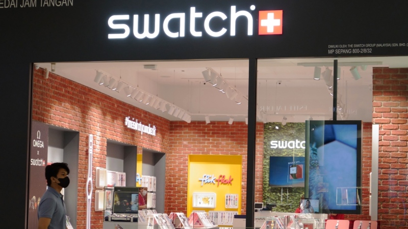 A man walks past a Swatch outlet at a shopping mall in Putrajaya, Malaysia, Aug. 10, 2023. (AP Photo/Vincent Thian, File)