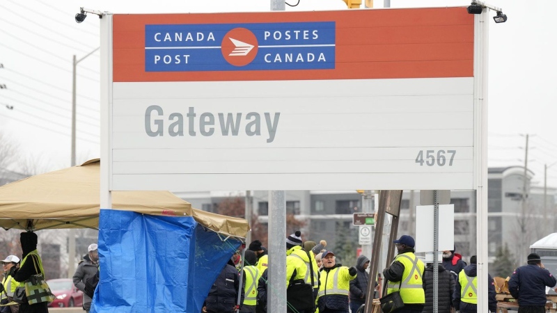 Canada Post workers walk the picket line while on strike in Mississauga, Ont., on November 20, 2024. THE CANADIAN PRESS/Nathan Denette