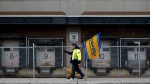 Striking Canada Post employees are seen at a Canada Post mail sorting facility during nation-wide strike action in Ottawa, on Monday, Nov. 18, 2024. (Spencer Colby, The Canadian Press)