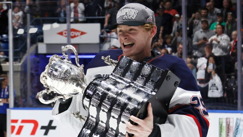 Saginaw Spirit goalie Andrew Oke (29) celebrates with the Memorial Cup trophy after a 4-3 win over the London Knights in Saginaw, Mich., on June 2, 2024. (Duane Burleson / The Canadian Press)