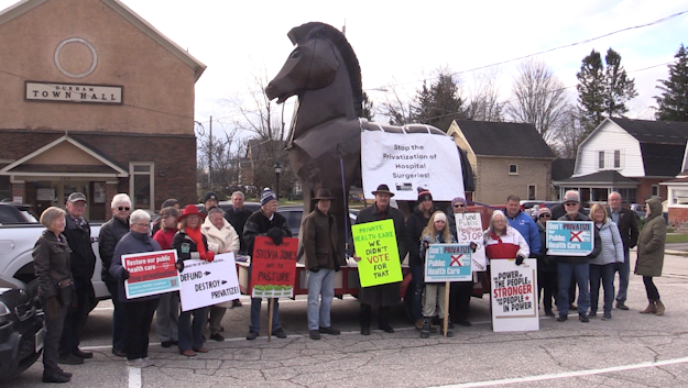 Members of the Grey Bruce Health Coalition stand with the “Trojan Horse Tour” in Durham on Nov. 27, 2024. (Scott Miller/CTV News London)