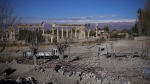 Damaged vehicles seen in front of the Roman temples of Baalbek in eastern Lebanon, Thursday, Nov. 28, 2024. (AP Photo/Hassan Ammar)