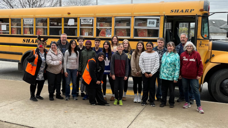 Staff and students pose in front of a school bus stuffed with cereal boxes (Source: Greater Essex County District School Board)