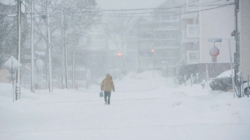 A pedestrian walks down the middle of the road on Victoria Street in downtown Moncton, N.B., on  Jan. 4, 2018. THE CANADIAN PRESS/Stephen MacGillivray