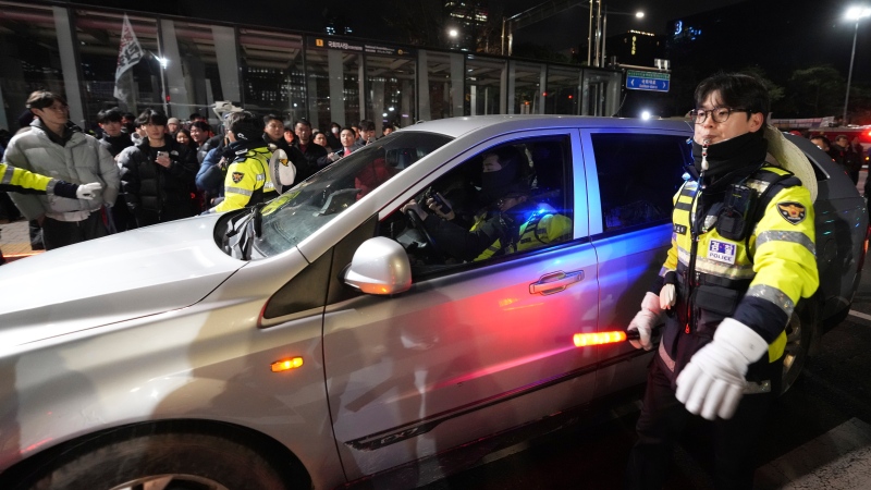 Military vehicles is escorted by police officers outside of the National Assembly in Seoul, South Korea, Wednesday, Dec. 4, 2024. (AP Photo/Lee Jin-man)