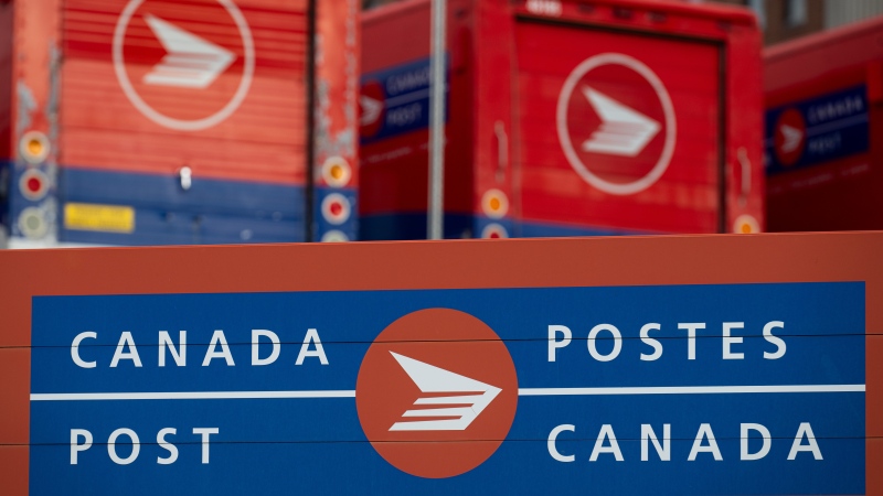 Canada Post signage and parked vehicles are seen at a Canada Post mail sorting facility during nation-wide strike action in Ottawa, on Monday, Nov. 18, 2024. THE CANADIAN PRESS/Spencer Colby