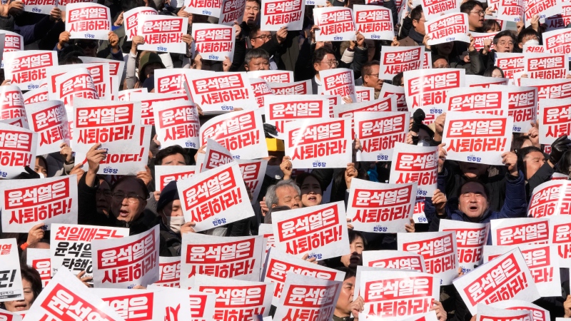 Members of main opposition Democratic Party stage a rally against South Korean President Yoon Suk Yeol at the National Assembly in Seoul, South Korea, Dec. 4, 2024. The signs read "Yoon Suk Yeol should resign." (AP Photo/Ahn Young-joon)