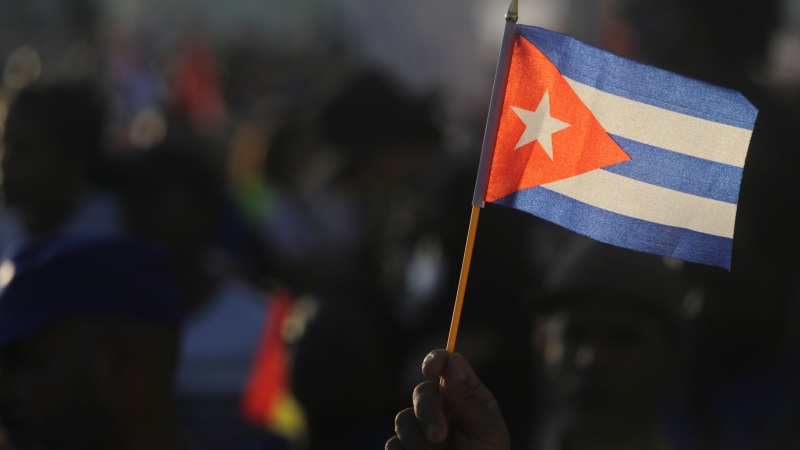 A person waves a Cuban flag during a gathering marking International Workers' Day at Anti-Imperialist Square in Havana, Cuba, May 1, 2024. (AP Photo/Ariel Ley)