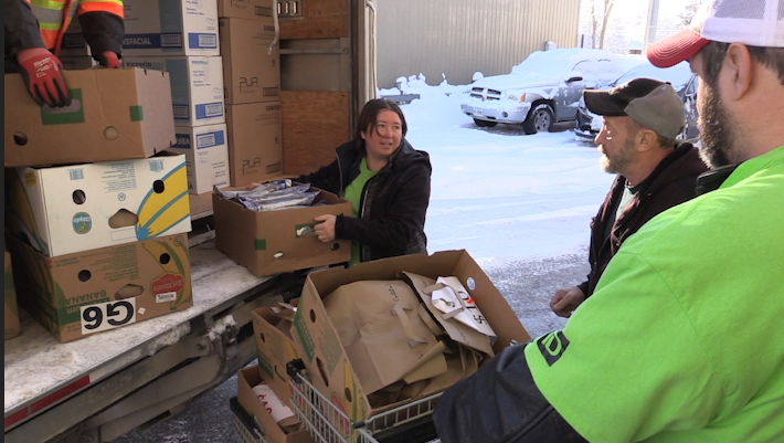 Volunteers with the North Huron Community Food Share unload food donations from the biggest food and fundraiser for the food bank, the CKNX Relief Food Drive in Wingham on December 3, 2024 (Scott Miller/CTV News London)