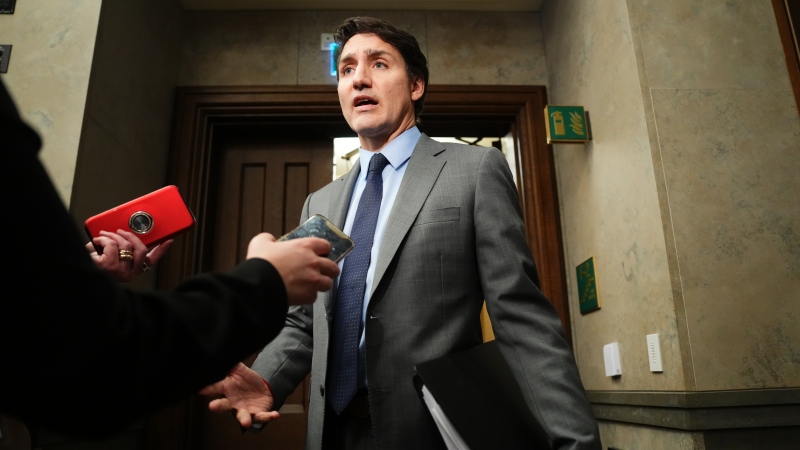 Prime Minister Justin Trudeau talks to media outside the House of Commons on Dec. 4, 2024. (Sean Kilpatrick / The Canadian Press)