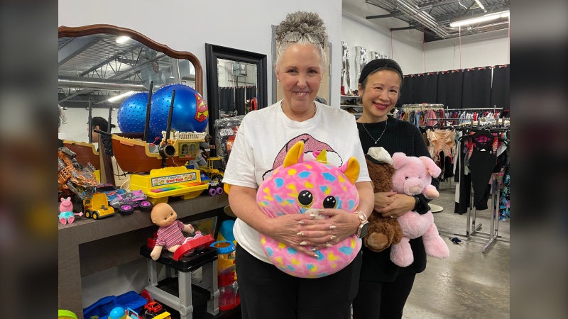 Shannon Shaban, owner of Dayzee's Fashions, is seen with the donated toys in her store.