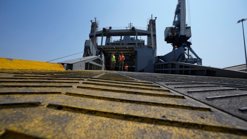 U.S soldiers stand on a docked U.S ship that will transport the Gaza aid, at the port in southern city of Larnaca, Cyprus, Wednesday, June 26, 2024. (AP Photo/Petros Karadjias) 