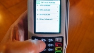 A payment terminal displays tip options at a restaurant Thursday, September 12, 2024 in Montreal. (THE CANADIAN PRESS/Ryan Remiorz)