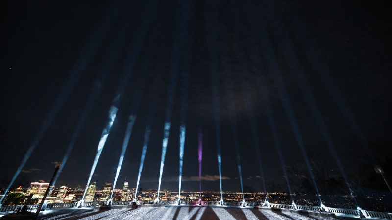 Fifteen beams of light are projected into the sky following a ceremony to honour the victims of the 1989 Polytechnique massacre in Montreal, Friday, December 6, 2024. Today marks the 35th anniversary of the shooting rampage that left 14 women dead. (Graham Hughes/The Canadian Press)