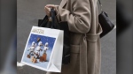 A shopper walks in downtown Montreal on December 19, 2023. (THE CANADIAN PRESS/Christinne Muschi)