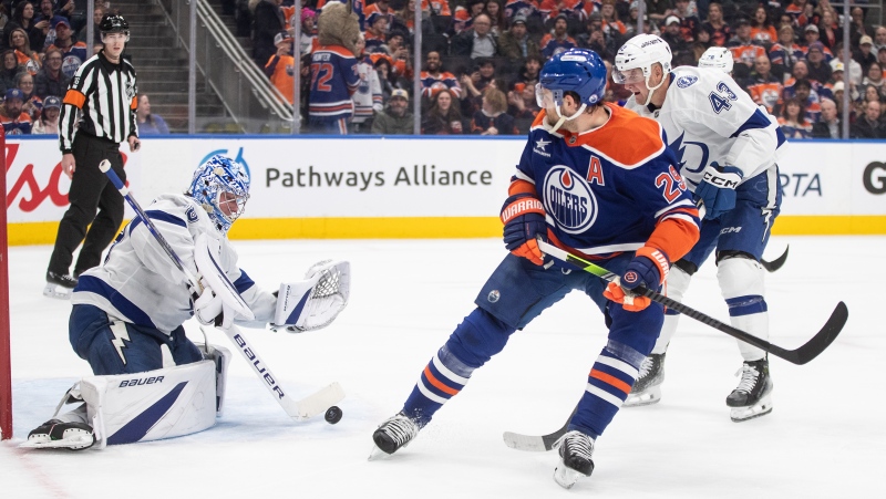 Tampa Bay Lightning goalie Andrei Vasilevskiy (88) makes a save on Edmonton Oilers' Leon Draisaitl (29) as Darren Raddysh (43) defends during second period NHL action in Edmonton on Tuesday, December 10, 2024. (Jason Franson / The Canadian Press) 