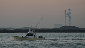 Boaters pass as SpaceX's mega rocket Starship prepares to launch for a test flight from Starbase in Boca Chica, Texas, Nov. 18, 2023. (AP Photo/Eric Gay)