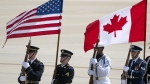 An honour guard marches in formation with U.S. and Canadian flags after the arrival of Canadian Prime Minister Justin Trudeau, at Andrews Air Force Base, Md., to attend the NATO summit in Washington, Monday, July 8, 2024. AP / Mark Schiefelbein