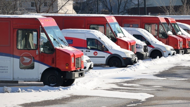 Canada Post vehicles sit covered in snow at a distribution facility after a strike that has lasted more than four weeks, in Ottawa on December 13, 2024. (Patrick Doyle/The Canadian Press)