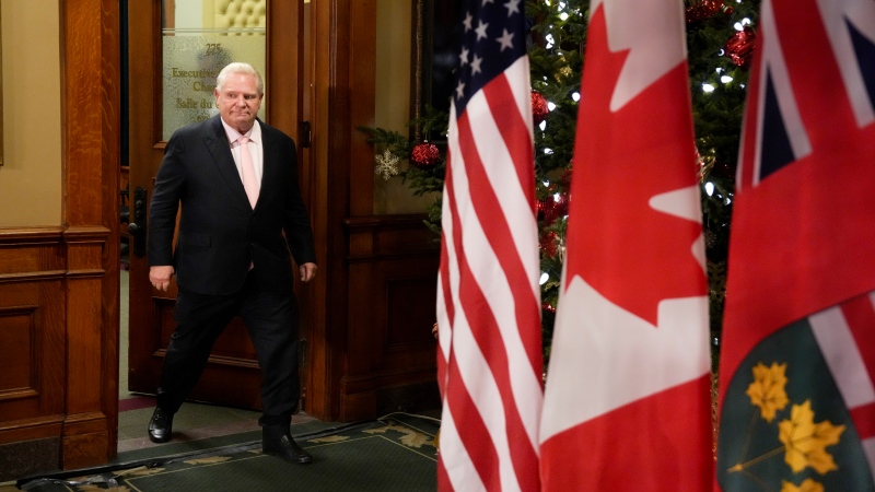 Ontario Premier Doug Ford steps out of an office to speak to the media outside of his office in the Queens Park legislature, in Toronto, Dec. 11, 2024. THE CANADIAN PRESS/Chris Young