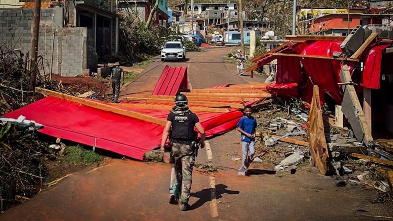 A French Gendarme walks among debris, Dec. 15, 2024, in Mayotte. (Gendarmerie Nationale via AP)