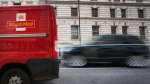 A car overtakes a Royal Mail delivery van, in Westminster in London, Jan. 25, 2024. (AP Photo/Kirsty Wigglesworth)