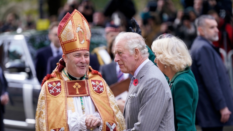 Archbishop of York Stephen Cottrell, left, welcomes Britain King Charles III and the Queen Consort, right, as they arrive at York Minster to attend a short service for the unveiling of a statue of Queen Elizabeth II, in the City of York, England, on Nov. 9, 2022. (Danny Lawson/Pool Photo via AP)