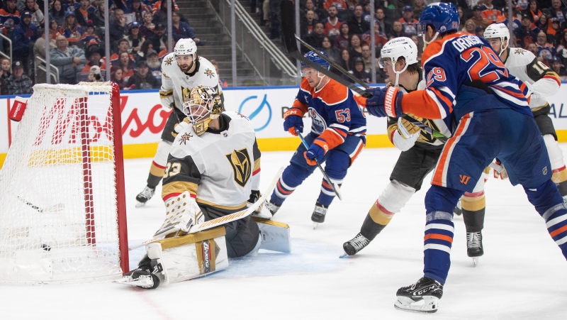 Vegas Golden Knights goalie Adin Hill (33) is scored on by Edmonton Oilers' Leon Draisaitl (29) during second period NHL action in Edmonton, Saturday, Dec. 14, 2024. (Jason Franson/The Canadian Press)