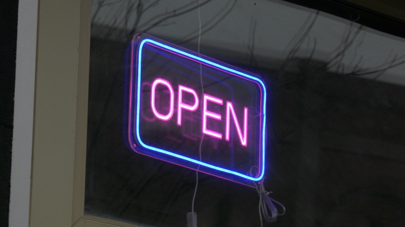 An open sign in the window of a business in Barrie, Ont. (CTV News/Christian D'Avino)