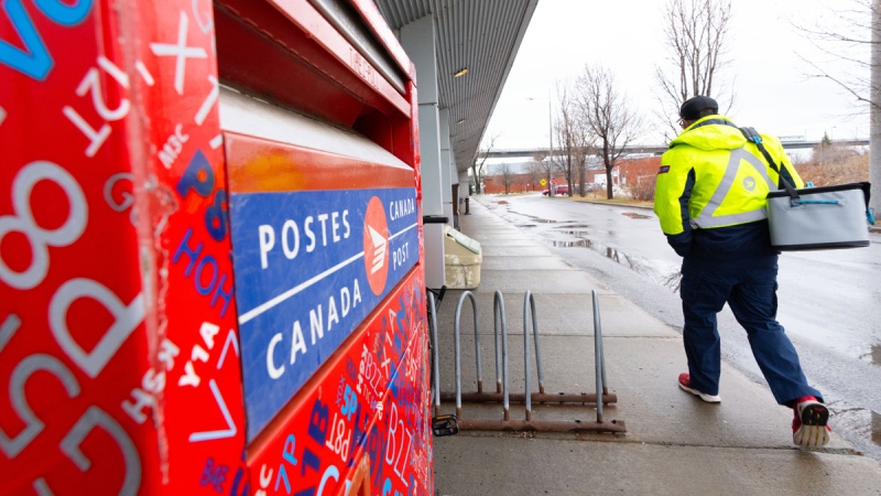 A Canada Post worker arrives for work in Montreal on Tuesday, Dec.17, 2024. Canada Post is resuming operations after a month-long strike by more than 55,000 postal workers left letters and parcels in limbo.THE CANADIAN PRESS/Christinne Muschi