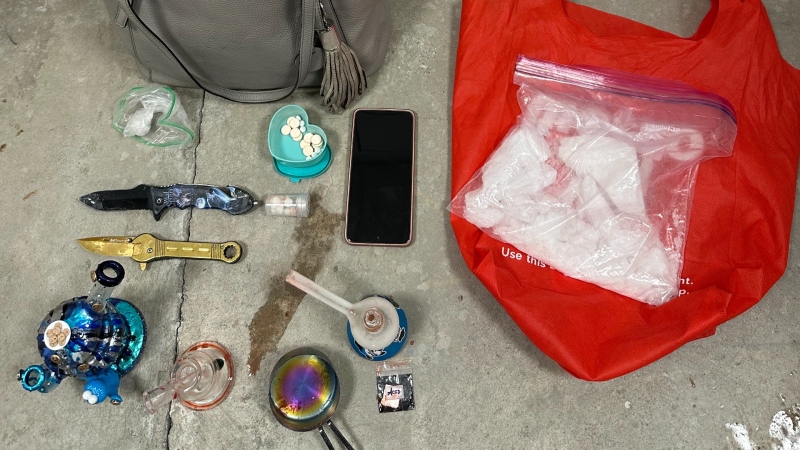 Police display evidence, including weapons and over a pound of suspected methamphetamine, allegedly seized during a traffic stop in Barrie, Ont., on Mon., Dec. 16, 2024. (Barrie Police Services/X)