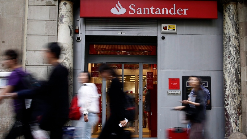 People walk past a Banco Santander office in Barcelona, Spain, June 7, 2017. (AP Photo/Manu Fernandez)